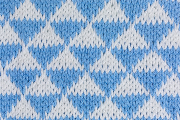 background of knitted fabric in white and blue with triangles