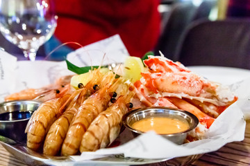 Crabs, shrimp, langoustines, scallops lay on a large platter.