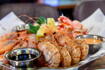 Crabs, shrimp, langoustines, scallops lay on a large platter.