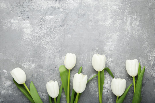 Fototapeta Bouquet of white tulips on grey wooden table