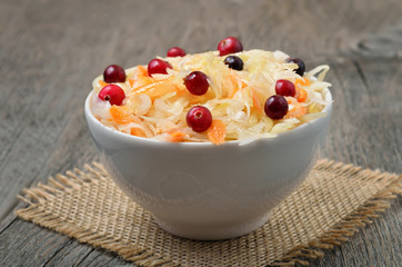 Sauerkraut and cranberries in white bowl