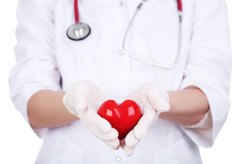 Female hands in gloves holding red heart