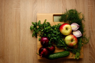 Fresh vegetables and fruits on bathroom scale, lose weight concept, copy space for text or object