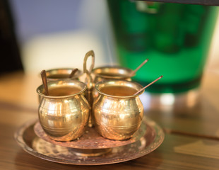 golden cups for coffee or tea on the table