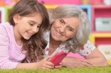 Smiling granny with her granddaughter