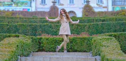 The labyrinth has passed. Young lady in coat has reached the goal and making curtsey.