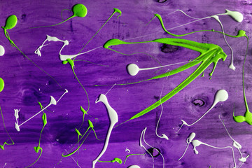 Artist working wooden table top with paint  marks spill all over the surface. Backgrounds...