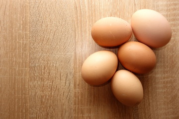 Eggs on rustic wooden background, view from overhead, copy space for your text or object