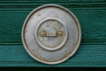 old gray lid on the green wall