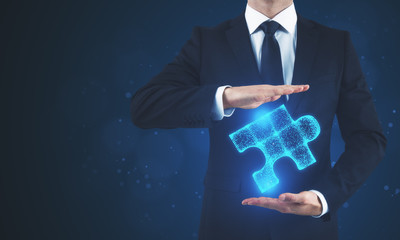 Man holding blue puzzle