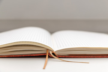 Open blank notepad on white background close-up