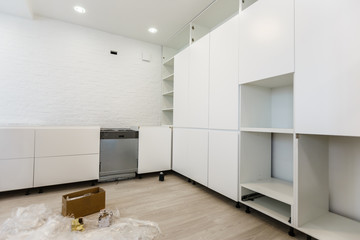 Fototapeta premium Installing new induction hob in modern kitchen kitchen installation of kitchen cabinet