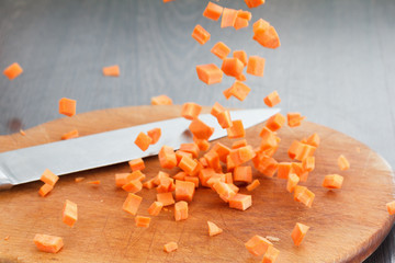 Carrot falls on the board for cutting.