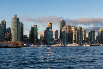 Fototapeta na wymiar Downtown City Skyline during a vibrant winter sunrise. Taken in Coal Harbour, Vancouver, British Columbia, Canada.