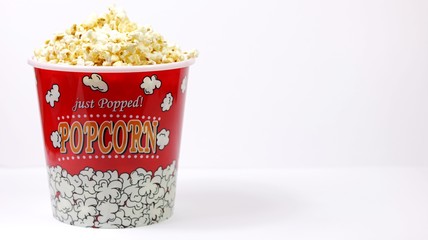 Popcorn in a bowl on white background with copy space