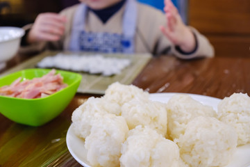 Cooking of traditional sushi rolls. The boy is dressed as a cook.