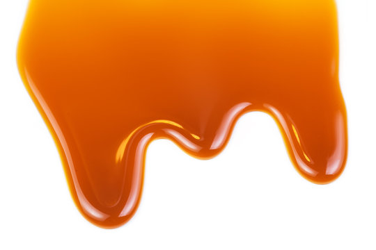 Sweet caramel sauce isolated on white background close up.