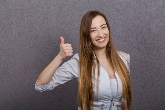 Attractive female doctor woman show thumbs up