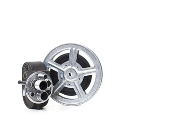 Fototapeta premium old 8 mm camera and film reel on white