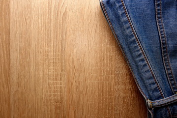 Blue denim jeans on wooden background with copy space for your design