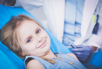 Little girl sitting in the dentists office