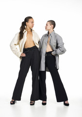 Two Topless girls posing on a white background.