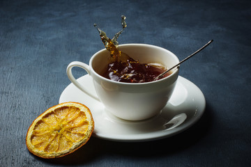 Black tea with a splash, spray and dried orange