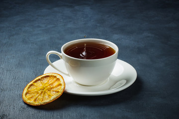 Black tea with a splash, spray and dried orange