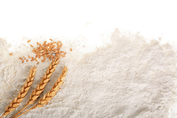 ears of wheat and pile of flour isolated on white background with copy space for your text. Top view. Flat lay