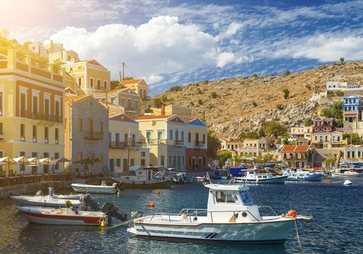 Greece, traditional view of Greek coastline - small fishing boats anchored at the wooden quay.
