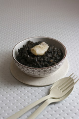Black rice with cuttlefish, on black cement dish