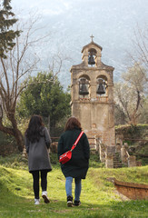Obraz premium woman near church in Prchanj in Montenegro.