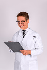Male Doctor standing with folder, on white background