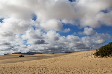 Fototapeta na wymiar Sand against cloudy sky