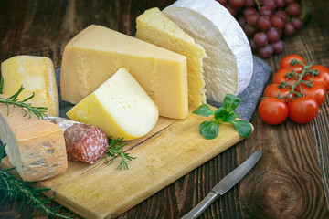 Cheeses with basil, rosemary, tomatoes, grapes and salame.