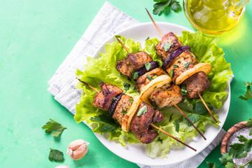 Grilled shish kebab or shashlik on green table.