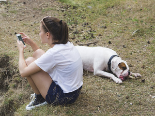 Young woman and her dog relaxing outdoors