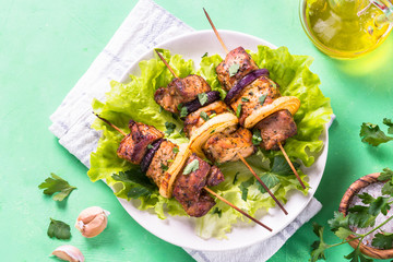Grilled shish kebab or shashlik on green table.