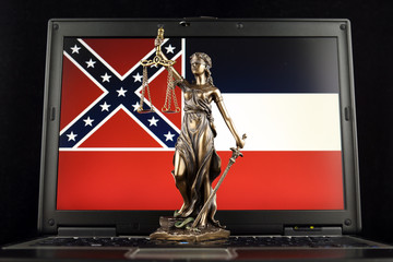 Symbol of law and justice with Mississippi State Flag on laptop. Studio shot.