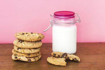 homemade white and black chocolate cookies on wood table with milk 