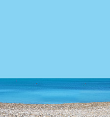 Blue sky, summer sea, pebble beach. Mediterranean summer landscape, skyline.  Summer time, beach background. Space for text