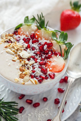 Smoothies bowl with strawberries, pomegranate, nuts. Healthy breakfast.