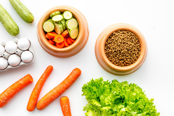 Dry food for dogs and cats based on raw meat and vegetables on white backgroud top view