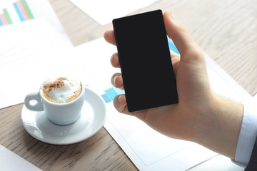 Close up of a business man using mobile smart phone