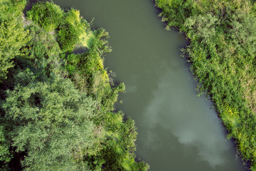 Aerial view of green meadow and river