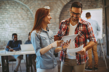 Young man and dwoman freelance team working on a project