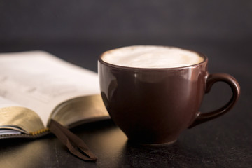 Coffee and a Bible on a Slate Tabletop