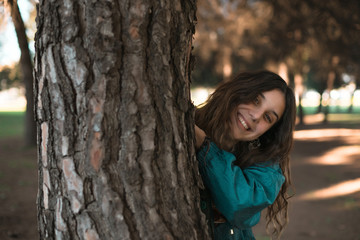 An attractive girl having fun in a sunny day inside a park in Seville, Spain.