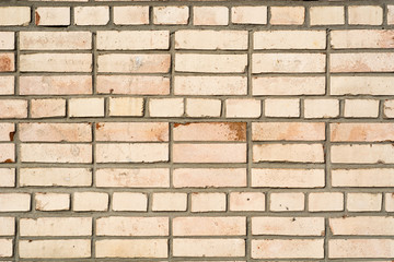 Background of the damaged old brick wall with horizontal masonry