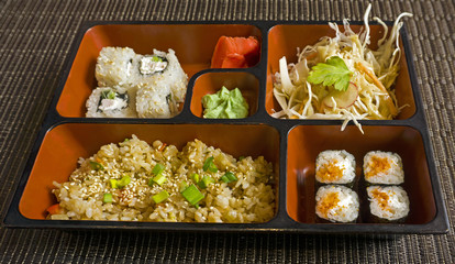 business lunch in Japanese style of several dishes in ceramic lunch-box